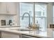 A stainless steel kitchen sink with a sleek faucet and bright natural light from the window at 221 Lucca Dr, Summerville, SC 29486
