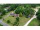 Aerial view of a brick home on a large lot, surrounded by lush trees and landscaping at 228 Dogwood Trl, Harleyville, SC 29448