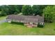A charming home seen from above with mature trees on an expansive and beautifully landscaped lot at 228 Dogwood Trl, Harleyville, SC 29448
