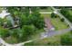 An aerial shot showcases a home with a pond, bridge, and a lush green landscape at 228 Dogwood Trl, Harleyville, SC 29448