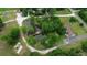 Overhead view of a property with a pond, wooded area, and house with ample parking space at 228 Dogwood Trl, Harleyville, SC 29448