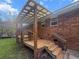 Spacious wooden back deck with a covered area, offering an excellent space for outdoor relaxation at 228 Dogwood Trl, Harleyville, SC 29448