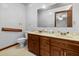Bathroom with double vanity, wood cabinets, and a large mirror at 228 Dogwood Trl, Harleyville, SC 29448