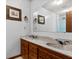 Bathroom with a double vanity, marble countertops, and framed artwork at 228 Dogwood Trl, Harleyville, SC 29448