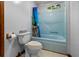 Bathroom with a tub and shower, a toilet, and a blue shower curtain at 228 Dogwood Trl, Harleyville, SC 29448