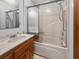 Traditional bathroom with a tub, shower with sliding glass door, vanity, and a mirrored wall at 228 Dogwood Trl, Harleyville, SC 29448