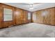 Spacious bedroom with neutral carpet and wood paneling on the walls at 228 Dogwood Trl, Harleyville, SC 29448