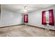 Bright bedroom with ceiling fan, plush carpet, and ample natural light from two windows at 228 Dogwood Trl, Harleyville, SC 29448