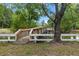 A wooden dock with white railings extends over the water, offering a peaceful spot to enjoy the natural surroundings at 228 Dogwood Trl, Harleyville, SC 29448