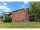 Brick home with a prominent chimney and mature trees in a spacious yard at 228 Dogwood Trl, Harleyville, SC 29448