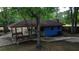 Charming blue cottage with a covered seating area, perfect for outdoor relaxation and enjoyment at 228 Dogwood Trl, Harleyville, SC 29448