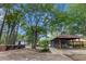 Rear exterior of blue house featuring an attached drive-through, canopy with picnic table seating at 228 Dogwood Trl, Harleyville, SC 29448