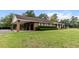 Spacious brick home with a well-manicured lawn and a convenient covered parking area at 228 Dogwood Trl, Harleyville, SC 29448