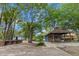 Rear exterior of blue house featuring an attached drive-through, canopy with picnic table seating at 228 Dogwood Trl, Harleyville, SC 29448