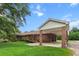 Brick home with a convenient carport, complemented by a lush green lawn and mature trees, enhancing its curb appeal at 228 Dogwood Trl, Harleyville, SC 29448
