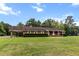 Spacious brick home with a covered carport and well-manicured landscaping at 228 Dogwood Trl, Harleyville, SC 29448