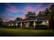 Charming brick home with a long covered porch and manicured landscaping at 228 Dogwood Trl, Harleyville, SC 29448
