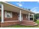 Inviting brick front porch with elegant white columns and a stepped entrance at 228 Dogwood Trl, Harleyville, SC 29448
