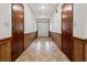 This hallway features wood paneling on the lower half of the walls and neutral flooring at 228 Dogwood Trl, Harleyville, SC 29448
