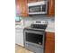 This kitchen features stainless steel appliances and wooden cabinets at 228 Dogwood Trl, Harleyville, SC 29448