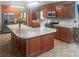 Spacious kitchen featuring a large island with bar seating, stainless steel appliances, and tile flooring at 228 Dogwood Trl, Harleyville, SC 29448