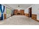 Large living room with brick fireplace, ceiling fans, and access to the backyard at 228 Dogwood Trl, Harleyville, SC 29448