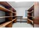 Walk-in pantry with built-in wooden shelving providing ample storage space at 228 Dogwood Trl, Harleyville, SC 29448