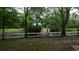 Pond with wooden bridge and scenic view of trees and lush greenery at 228 Dogwood Trl, Harleyville, SC 29448