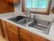 This kitchen features a stainless steel double sink beneath a window at 228 Dogwood Trl, Harleyville, SC 29448
