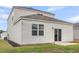 Backyard view showcases the home's exterior, patio, and a grassy area at 244 Wild Strawberry Ln, Moncks Corner, SC 29461
