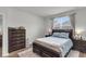 Cozy bedroom featuring a comfortable bed, window, dresser, and wood-look flooring at 244 Wild Strawberry Ln, Moncks Corner, SC 29461