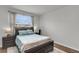 Comfortable bedroom with large window, neutral walls, dark wood furniture, and modern decor at 244 Wild Strawberry Ln, Moncks Corner, SC 29461