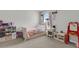 Cozy bedroom with a toddler bed, complemented by a bright window and play area at 244 Wild Strawberry Ln, Moncks Corner, SC 29461