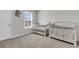 Bedroom with two white cribs, a window, and neutral carpet at 244 Wild Strawberry Ln, Moncks Corner, SC 29461