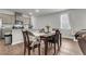 Bright dining room with dark wood table, modern chairs, and breakfast bar with seating at 244 Wild Strawberry Ln, Moncks Corner, SC 29461