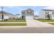 Two-story grey home features a two-car garage, black shutters, green grass, and ample driveway space at 244 Wild Strawberry Ln, Moncks Corner, SC 29461