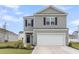 Charming two-story home with a two-car garage, landscaped yard, and grey siding with black shutters at 244 Wild Strawberry Ln, Moncks Corner, SC 29461