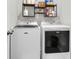 Laundry room featuring a Maytag washer and dryer with storage shelves above at 244 Wild Strawberry Ln, Moncks Corner, SC 29461