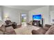 Open living room with large television, comfortable couches, and sliding glass doors to backyard at 244 Wild Strawberry Ln, Moncks Corner, SC 29461