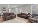 Bright open concept living room with comfortable couches, natural light, and wood-look flooring at 244 Wild Strawberry Ln, Moncks Corner, SC 29461