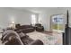 Cozy living room with plush couches, patterned rug, and sliding glass doors to the backyard at 244 Wild Strawberry Ln, Moncks Corner, SC 29461