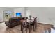 Open concept living room featuring a dark wood dining table, couch, and sliding glass doors at 244 Wild Strawberry Ln, Moncks Corner, SC 29461