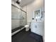 Modern bathroom with sleek black and white tile, a glass-enclosed shower, and a backlit mirror over the vanity at 2508 Corona St, North Charleston, SC 29405