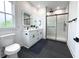 Modern bathroom featuring a double vanity, black fixtures, and a glass-enclosed shower with white tiles at 2508 Corona St, North Charleston, SC 29405