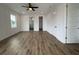 Spacious bedroom with a ceiling fan, wood floors, and doorways to the bathroom and walk-in closet at 2508 Corona St, North Charleston, SC 29405
