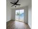 Bright bedroom with wood floors, ceiling fan, and sliding glass doors that lead to an outdoor balcony at 2508 Corona St, North Charleston, SC 29405