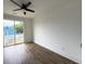 Bright bedroom featuring hardwood floors, a modern ceiling fan, and sliding glass doors leading to a deck at 2508 Corona St, North Charleston, SC 29405