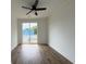 Bright bedroom with wood floors, ceiling fan, and sliding glass doors that lead to an outdoor balcony at 2508 Corona St, North Charleston, SC 29405
