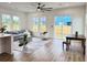 Cozy living room featuring lots of windows, wood floors, modern decor, and an updated ceiling fan at 2508 Corona St, North Charleston, SC 29405