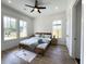 Serene main bedroom features a modern accent wall, wood floors, large windows, and ample natural light at 2508 Corona St, North Charleston, SC 29405